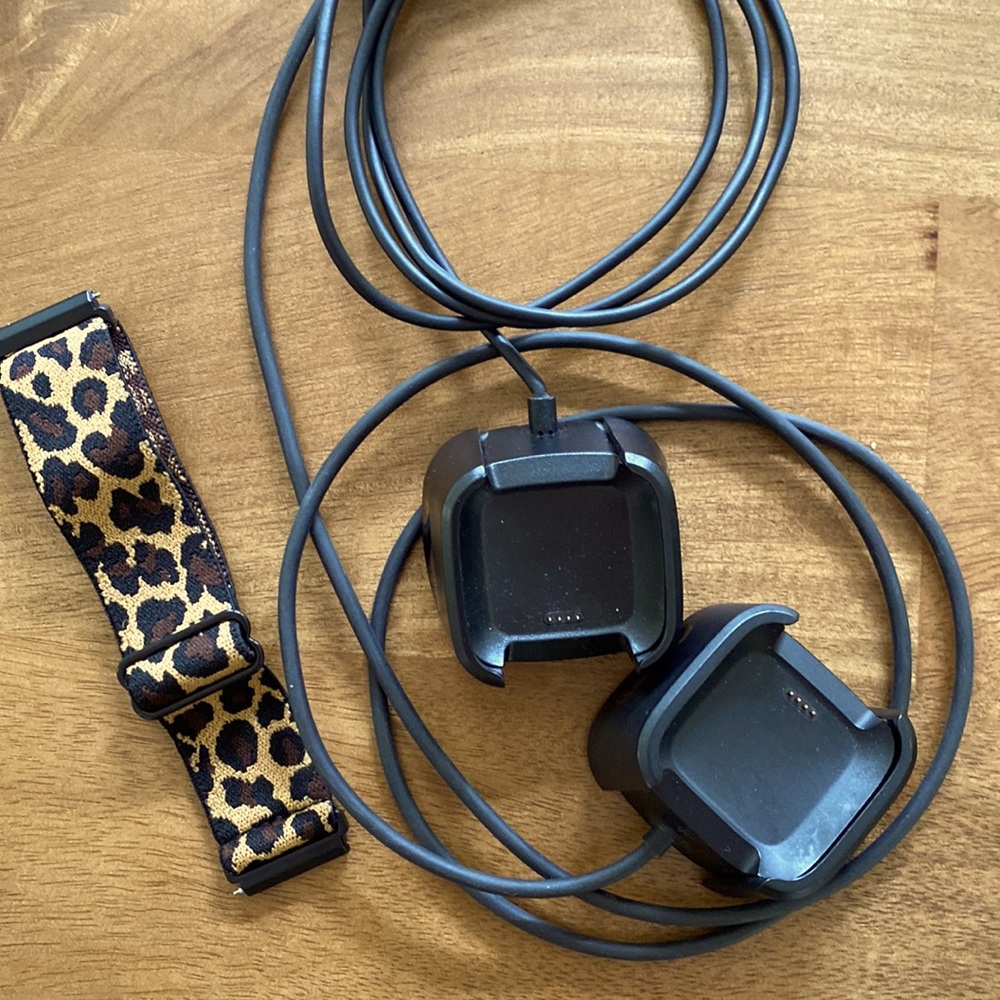 Two Fitbit (versa) chargers, elastic wristband.